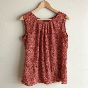 Sleeveless Mosaic Blouse with pin tucked neckline.